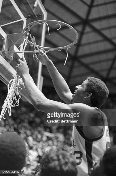Earvin Johnson, Michigan State's most Valuable Player Award winner at the NCAA basketball championship game at Utah University, uses a pair of...