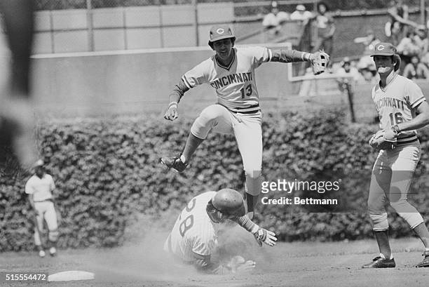 Cincinnati Reds short stop Dave Concepcion leaps over Chicago Cubs Gary Martin as he slides in at 2nd, on the front end of a doubleplay, during the...