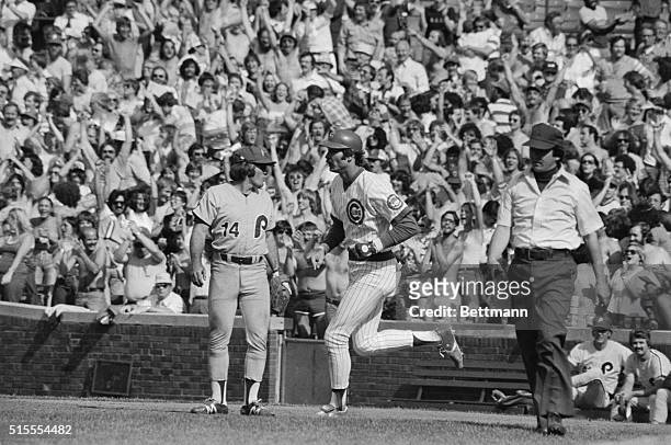 Pete Rose at first for Philadelphia looks the other way as Cubs' Dave Kingman rounds the bases in the sixth inning after hitting his third homerun of...