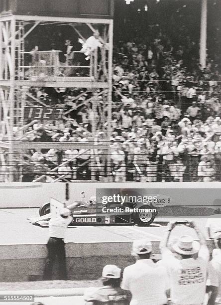 Indianapolis 500 Speedway, Indiana: Pat Vidan gives Rick Mears the checkered flag as he flashes over the finish line to win his first Indianapolis...