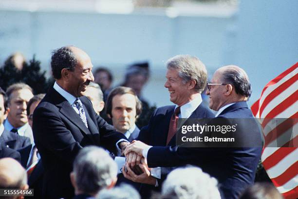 Washington, DC: President Jimmy Carter, Anwar al Sadat and Menachem Begin in three way handshake after signing of peace treaty.