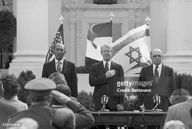 Washington, DC- Egyptian President Anwar Sadat, President Jimmy Carter and Israeli Prime Minister Menachem Begin stand at attention during the...