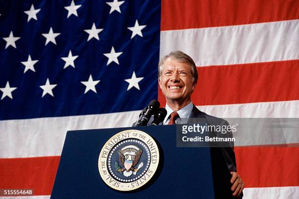 Elk City, Oklahoma: President Jimmy Carter addressing a town meeting. American flag is hung in background.
