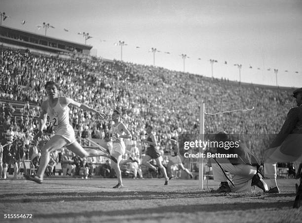 Lutt of Argentina is shown winning the 3rd heat of the semifinal of the 200 meter event in Los Angeles.