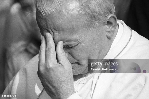 Krakow, Poland- Emotions show on the face of Pope John Paul II as he stands in front of the grave of his parents and brother at the Krakow Military...