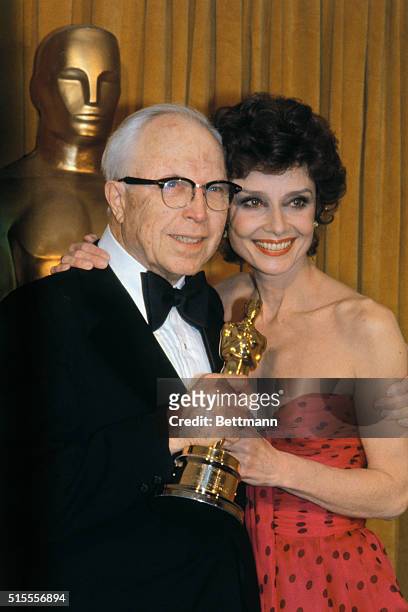 Director King Vidor holds Special Award "Oscar," as actress Audrey Hepburn looks on.