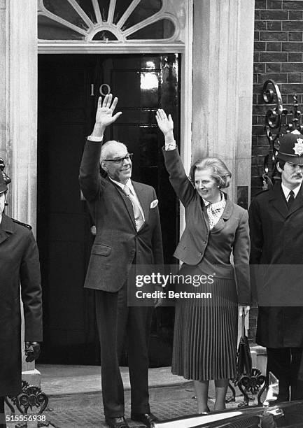 London, England- Britain's new Prime Minister, Margaret Thatcher, and her husband, Denis, wave while standing ont he steps of No. 10 Downing Street...
