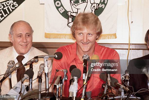 College basketball player of the year, Larry Bird of Indiana State is all smiles with Celtics' General manager Red Auerbach, after signing the Bird...