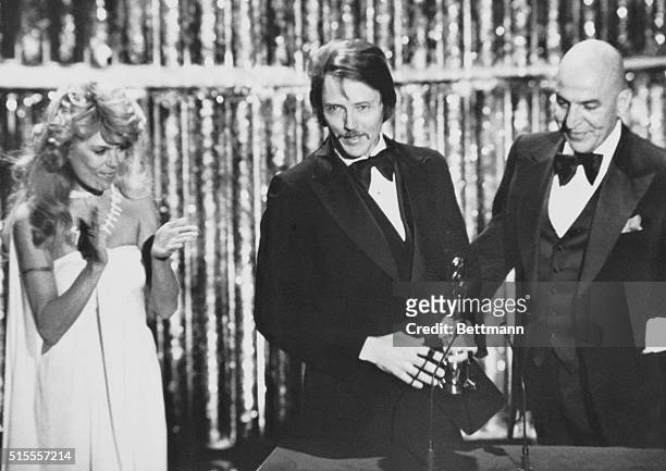 Actress Dyan Cannon and actor Telly Savalas , congratulate actor Christopher Walken on stage as he accepts his Best Supporting Actor Oscar at the...