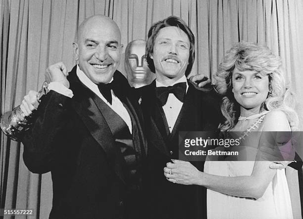 Actor Telly Savalas and actress Dyan Cannon hug actor Christopher Walken after Walken won the Best Supporting Actor Oscar for his role in The Deer...