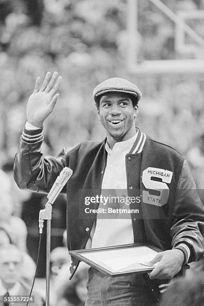 Happy Earvin "Magic" Johnson waves to the more than 10,000 Michigan State basketball fans who filled Jenison Fieldhouse to pay tribute to the NCAA...