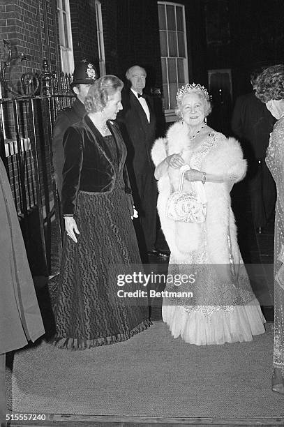 London, England- Britain's Prime Minister, Margaret Thatcher, greets the Queen Mother upon her arrival at 10 Downing Street. The Prime Minister...