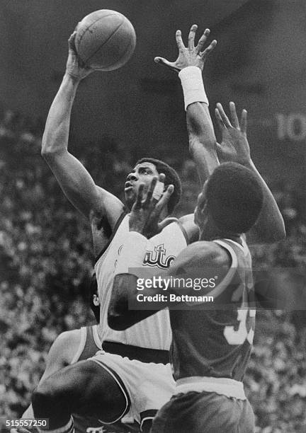 Michigan State's guard Earvin Johnson does his "magic" thing as he drives up and around LSU's forward Richard Kaye for a 2-point layup shot in 1st...