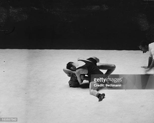 August 4 Los Angeles: Joseph Reid of England forces the shoulders of Zervinis Georges of Greece to the mat during the Bantam weight events of the...