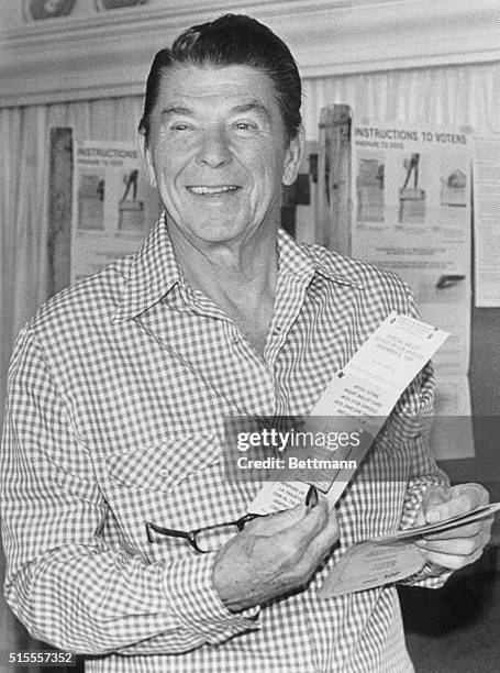 Pacific Palisades, California: Ronald Reagan is all smiles as he shows his ballot to newspeople after he marked his ballot for president. Reagan will...