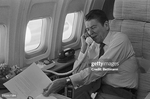 Aboard Air Force One- President Ronald Reagan talks to Senator Pete Domenici aboard Air Force One as the President used the five-and-one-half-hour...