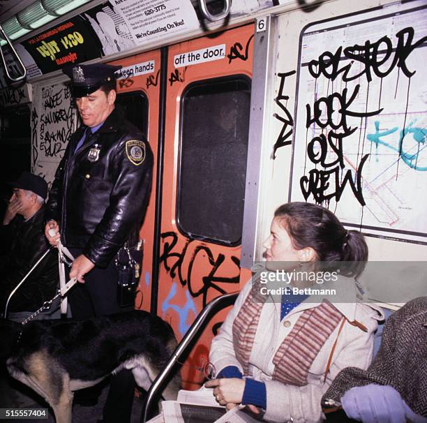New York: Transit Police Officer Ed Provenzana and his dog, "Hang on", ride subway December 15, as New York City began patrolling subway system with...