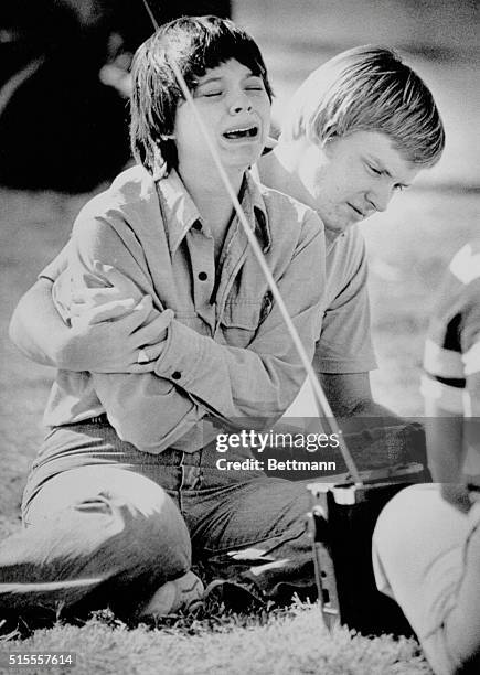 Young girl weeps as she listens to John Lennon's song, "Imagine," broadcast on a local radio station, during a tribute to the late former Beatle who...