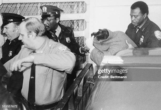 Mark David Chapman , accused assassin of former Beatle John Lennon, is protected by heavy security on return to Bellevue Hospital 12/11 following...