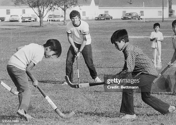 John Lennon's accused killer David Chapman is shown playing with a group of Vietnamese children at Fort Chaffee, Arkansas, in 1975. Chapman was...