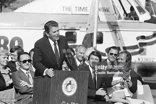 Speaking to a partisan crowd of Orange County residents Ronald Reagan is applauded by California Lt. Governor Mike Curb and entertainer pat Boone ....