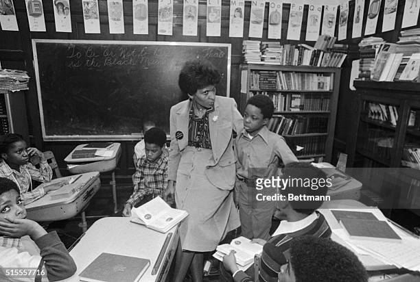 Teacher Marva Collins has her arm around a student at her inner-city Westside Preparatory School, where "problem children", kicked out of other...