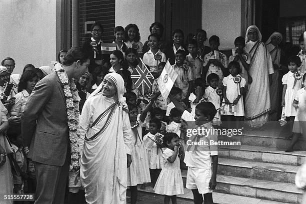 Prince Charles with Mother Teresa at Shu Bhawan children's home run by Mother Teresa. Children welcome the Prince at the entrance by holding flags of...