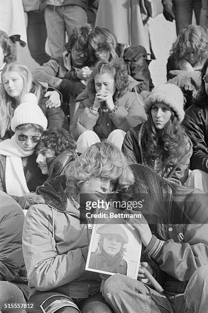 Lisa Conklin and Diana Gerbec both from Columbus, attended the memorial rally for John Lennon and here observe the ten minutes of silence requested...