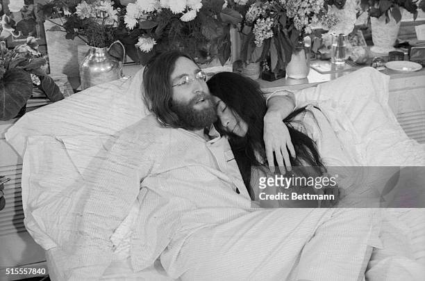 Yoko and John...Beatle John Lennon and Yoko Ono, his bride of three months at the time this photo was made in Montreal in June 1969, pose in bed. His...