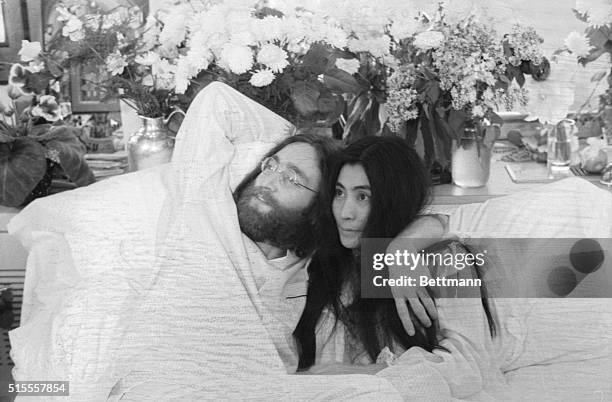 Yoko and John...Beatle John Lennon and Yoko Ono, his bride of three months at the time this photo was made in Montreal in June 1969, pose in bed. His...