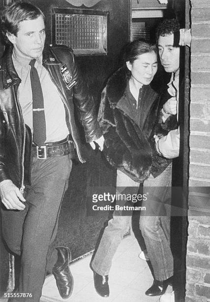 Yoko Ono, wife of former Beatle John Lennon, leaves the Roosevelt Hospital here following shooting of her husband 12/8. Lennon died in the emergency...