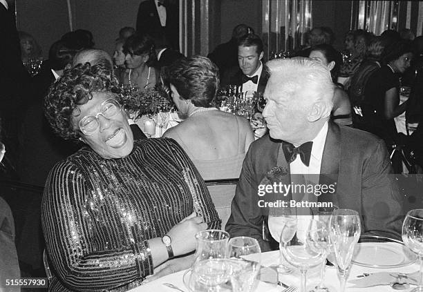 American singer Ella Fitzgerald laughing with a friend at the 1980 Lord & Taylor Rose Award, where she was a recipient of the award for making the...