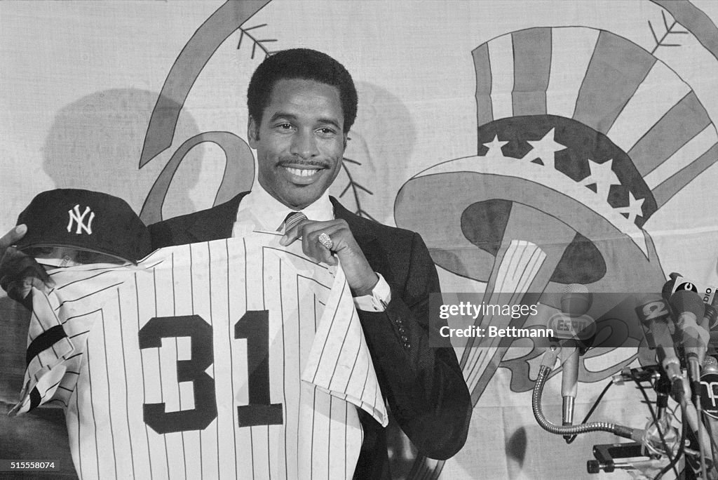 Dave Winfield Holding Shirt and Cap