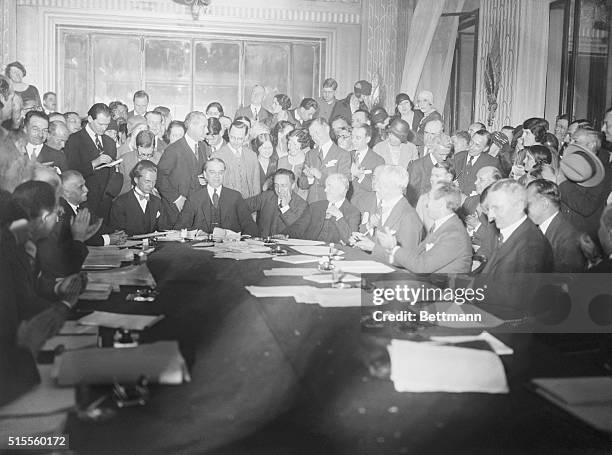 This photo shows representatives of countrymen at the table when the accord on the Reparation question was signed in Paris, at the Hotel George V....