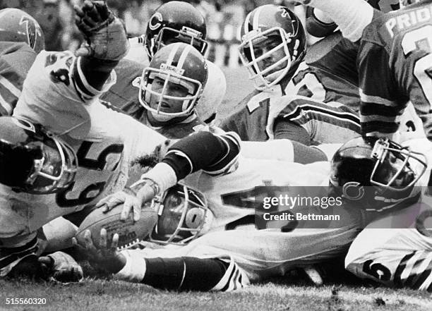 Chicago Bears' running back Walter Payton , puts the ball over the goal line to score the first touchdown in the first quarter against the Atlanta...