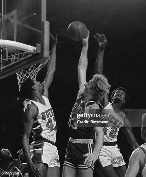 Milwaukee Bucks Mickey Johnson and (420 Harvey Catchings tried to block a shot by Boston Celtics' Larry Bird during the Boston-Celtics 11/30.