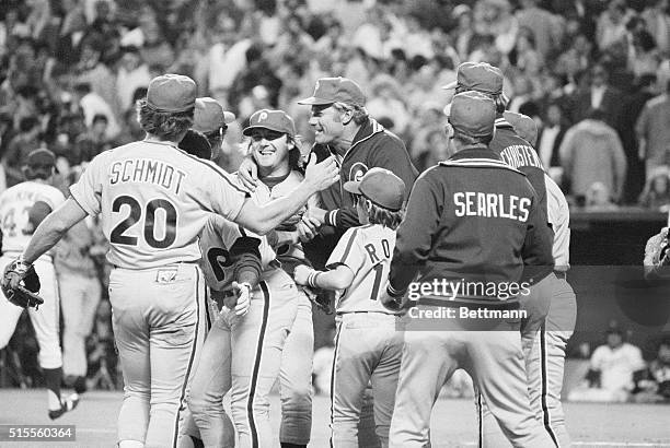 Philadelphia Phillies pitcher Tug McGraw is hugged by his coach, Dallas Green , and teammates after coming on in relief to beat the Kansas City...