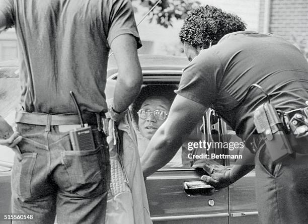 Wayne Williams is shown talking to police outside his home on June 9th. Later on June 21, he was arrested and charged with one count of homicide in...