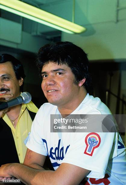 While sitting in his locker room, baseball player Fernando Valenzuela gives an interview.