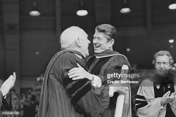 South Bend, IND.: Class of '81. Old friends, actor Pat O'Brien and President Ronald Reagan embrace, May 17th, as former Secretary of State Edmund...