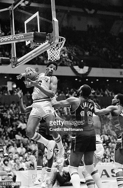 Sixers' Julius Erving gets an offensive rebound from Bucks' Bob Lanier then went back up and scored two of his game high 38 points in the second half...