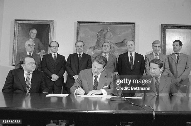 Washington, D.C.: President Reagan sings a executive order creating a Presidential Council on Integrity and Efficiency to fight fraud and waste in...