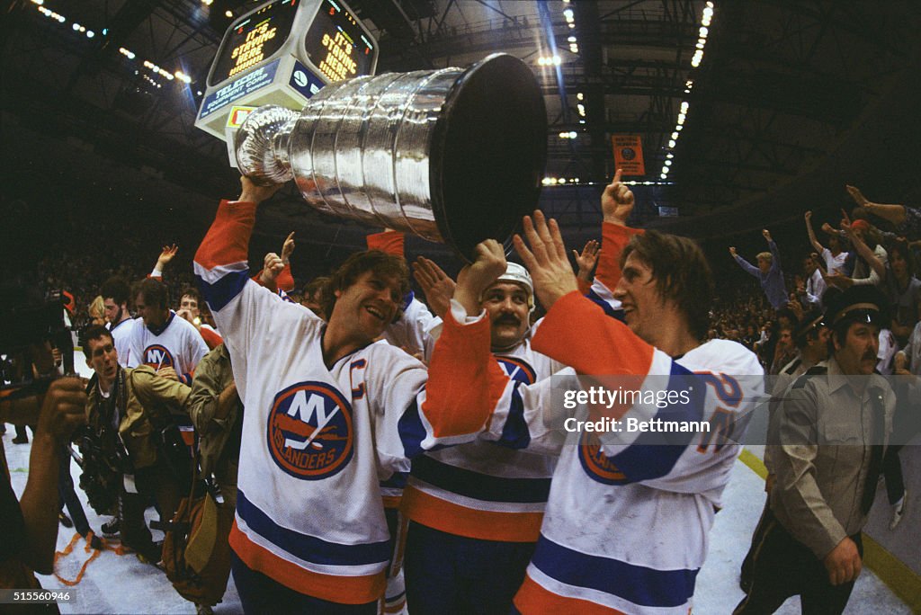 Hockey Players Carrying Trophy