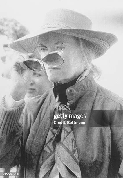 Newport, R.I.: Reclusive tobacco heiress Doris Duke peers from behind sunglasses as she watches pianist Dave Brubeck perform here during return of...