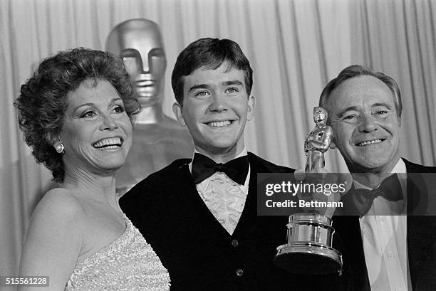 Timothy Hutton holds up his Oscar with presenters Mary Tyler Moore and Jack Lemmon , after he was awarded the Best Performance by an Actor in a...