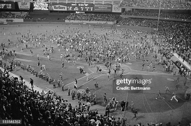 Yankee fans take over Yankees Stadium to celebrate New York's 7-3 victory over Milwaukee for American League east title.