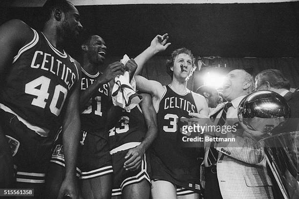 Boston Celtics general manager Red Auerbach laughs after Larry Bird stole his cigar during a victory celebration, after the Celtics beat the Houston...