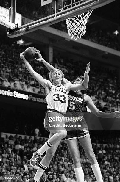 Houston Rockets' Billy Paultz gets his hand on the ball as the Celtics' Larry Bird drives toward the base during the first quarter action of game 1...