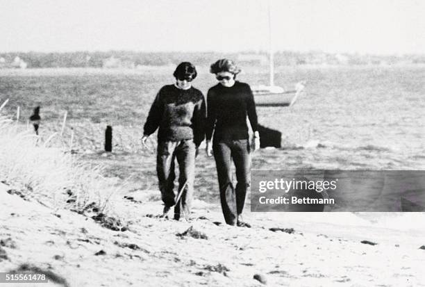 Jackie Kennedy Onassis with an unidentified companion friend walk along the beach at the Kennedy Compound. Onassis along with other Kennedy members...