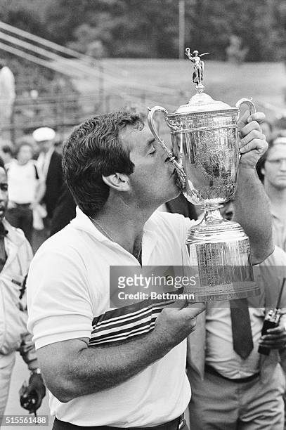Mamaroneck, New York: Fuzzy Zoeller kisses the United States Open Championship trophy at Winged Foot Club in Mamaroneck, New York, June 18, after...